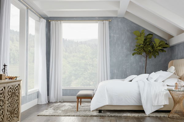 Bedroom design showcasing a light, flowing window shade
