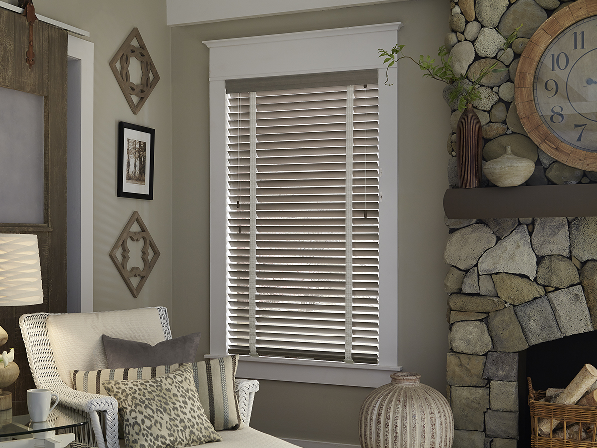 Real wood blinds pictured in a living room space