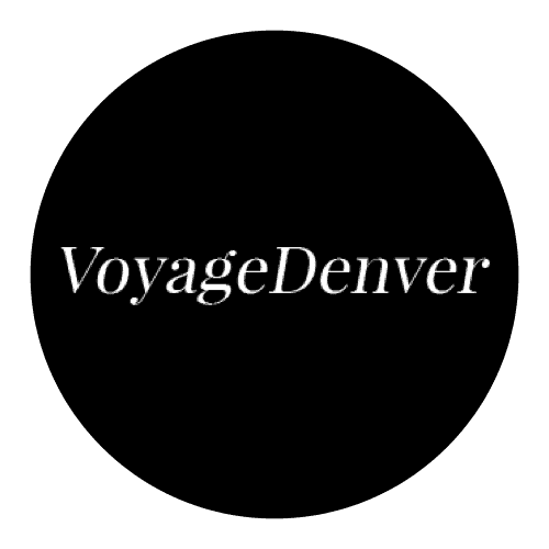 A black circular logo with the text "voyagedenver" written in white serif font.
