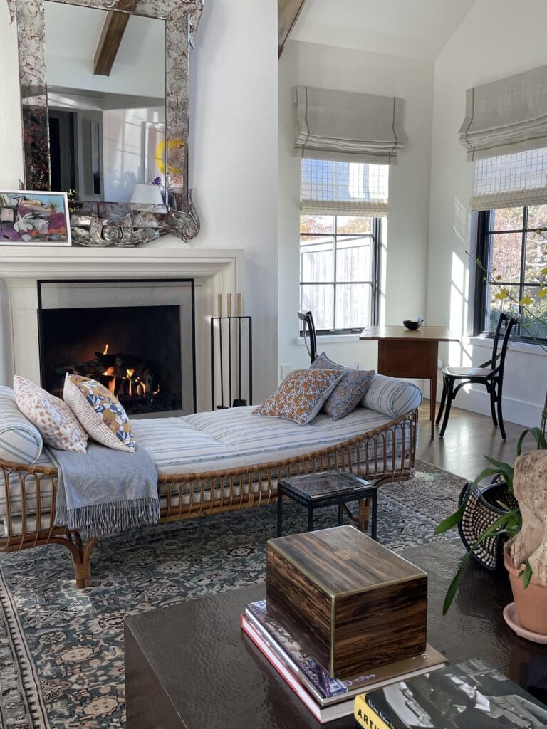 Custom Roman shades in a bright living space with fireplace